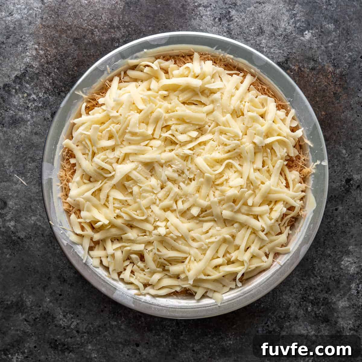 overhead: cheese layer on top of filo dough in a 9-inch pan
