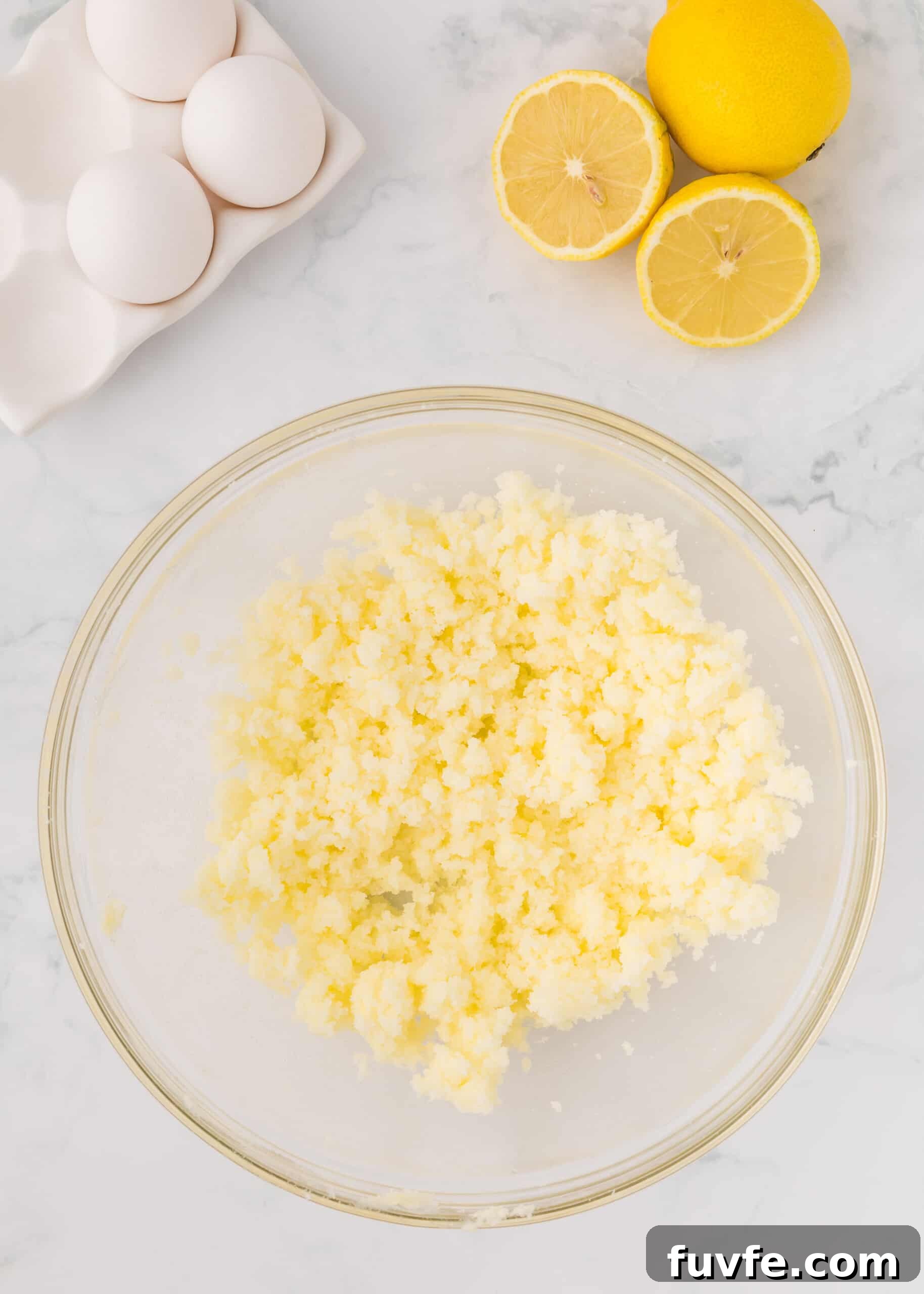 Zesty Iced Lemon Loaf Recipe for a Moist Citrus Cake 6 Butter and sugar beaten together in a glass mixing bowl.