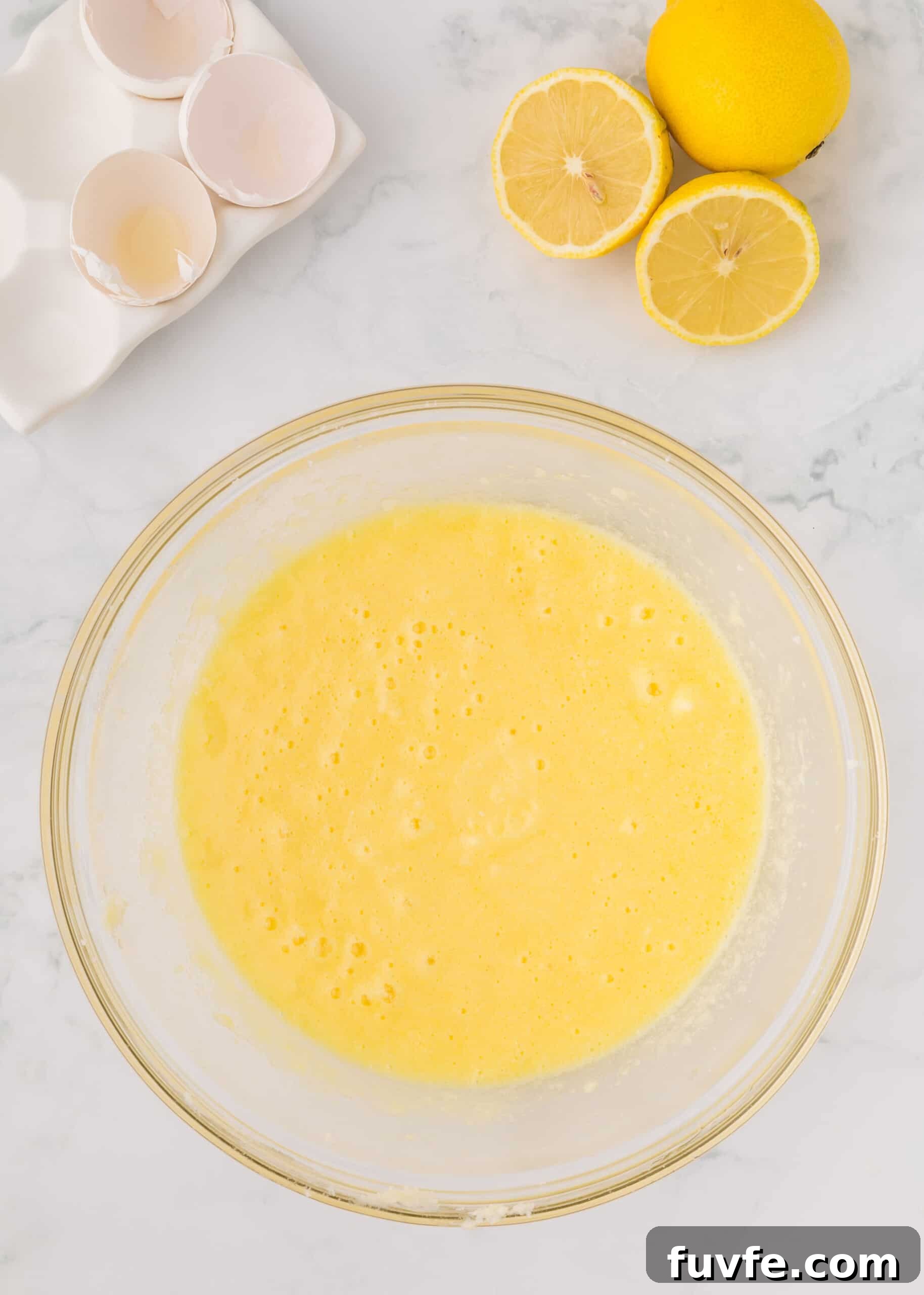 Zesty Iced Lemon Loaf Recipe for a Moist Citrus Cake 7 Eggs, sour cream, lemon extract added to sugar and butter.