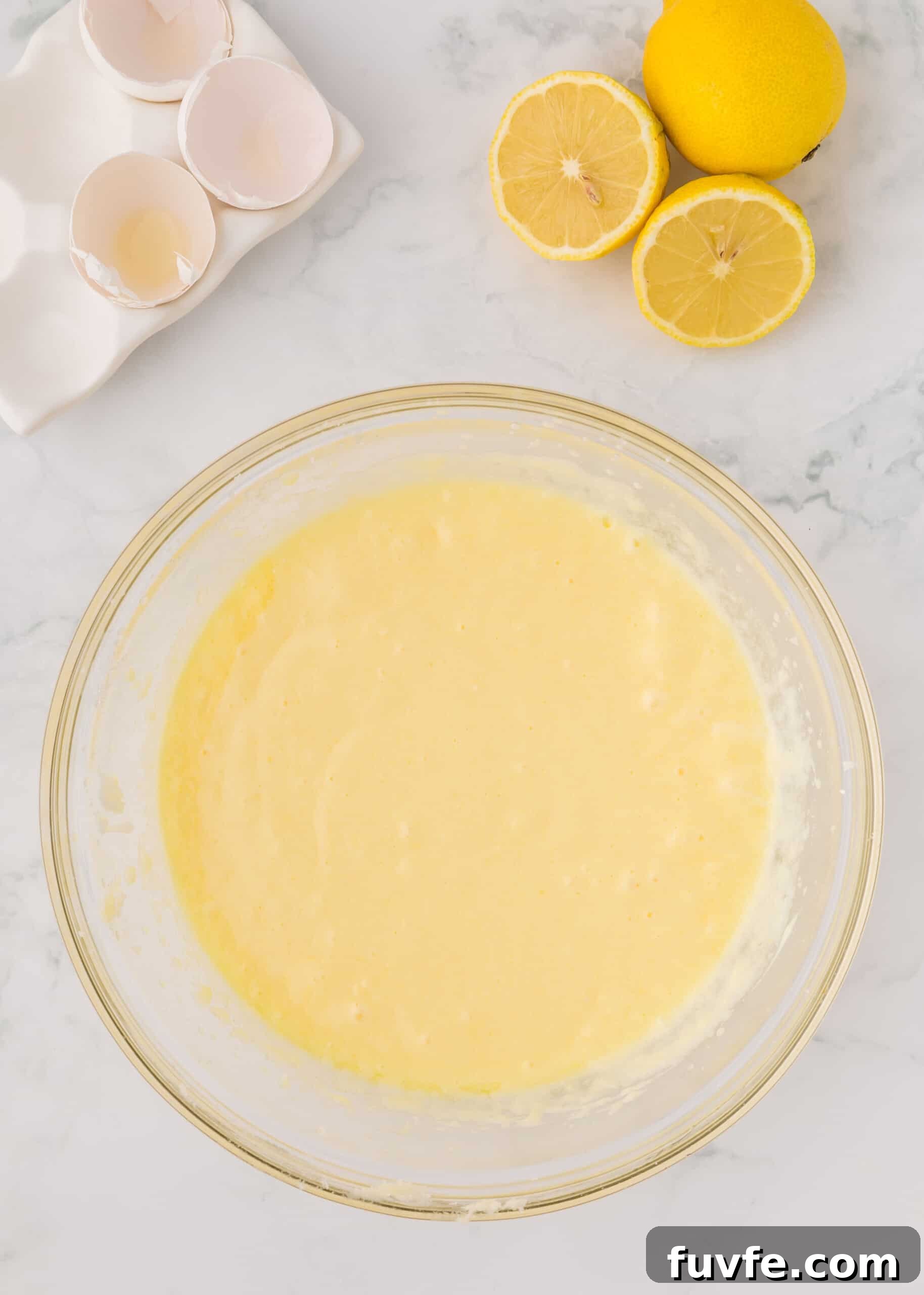 Zesty Iced Lemon Loaf Recipe for a Moist Citrus Cake 8 Flour, baking powder, baking soda, salt, lemon zest added to batter mixture.