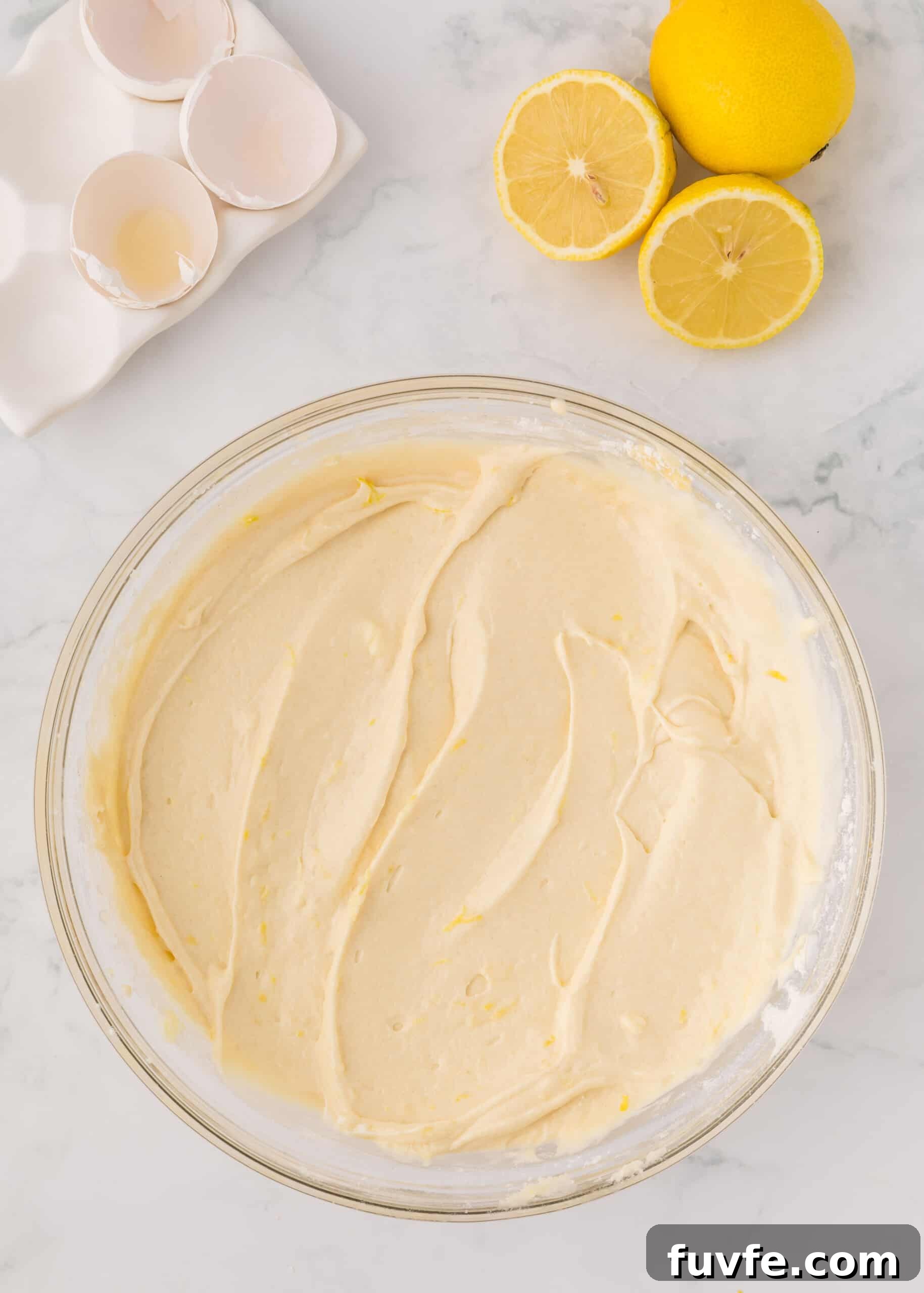 Zesty Iced Lemon Loaf Recipe for a Moist Citrus Cake 9 Lemon loaf batter in a glass mixing bowl.