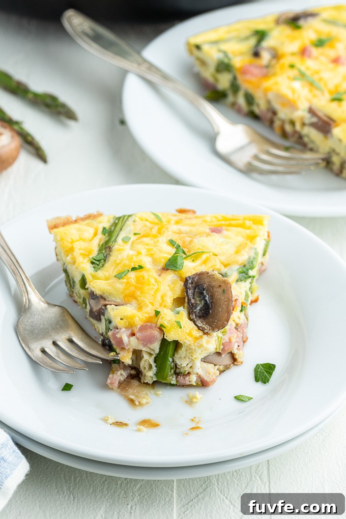 Savory Ham and Cheese Frittata for Brunch 8 Ham frittata on a plate with bite taken out of it
