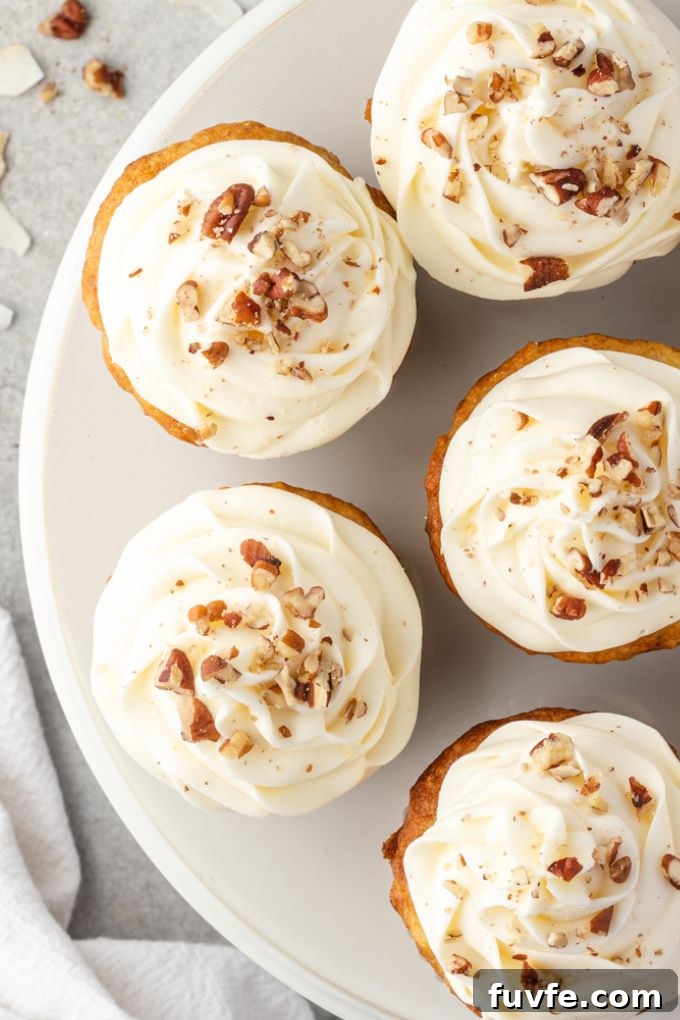 Platter of frosted hummingbird cupcakes garnished with toasted pecans
