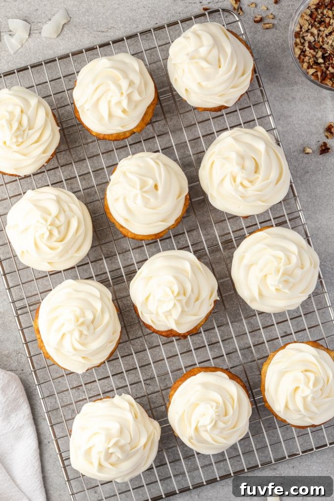 Frosted hummingbird cupcakes on a wire rack