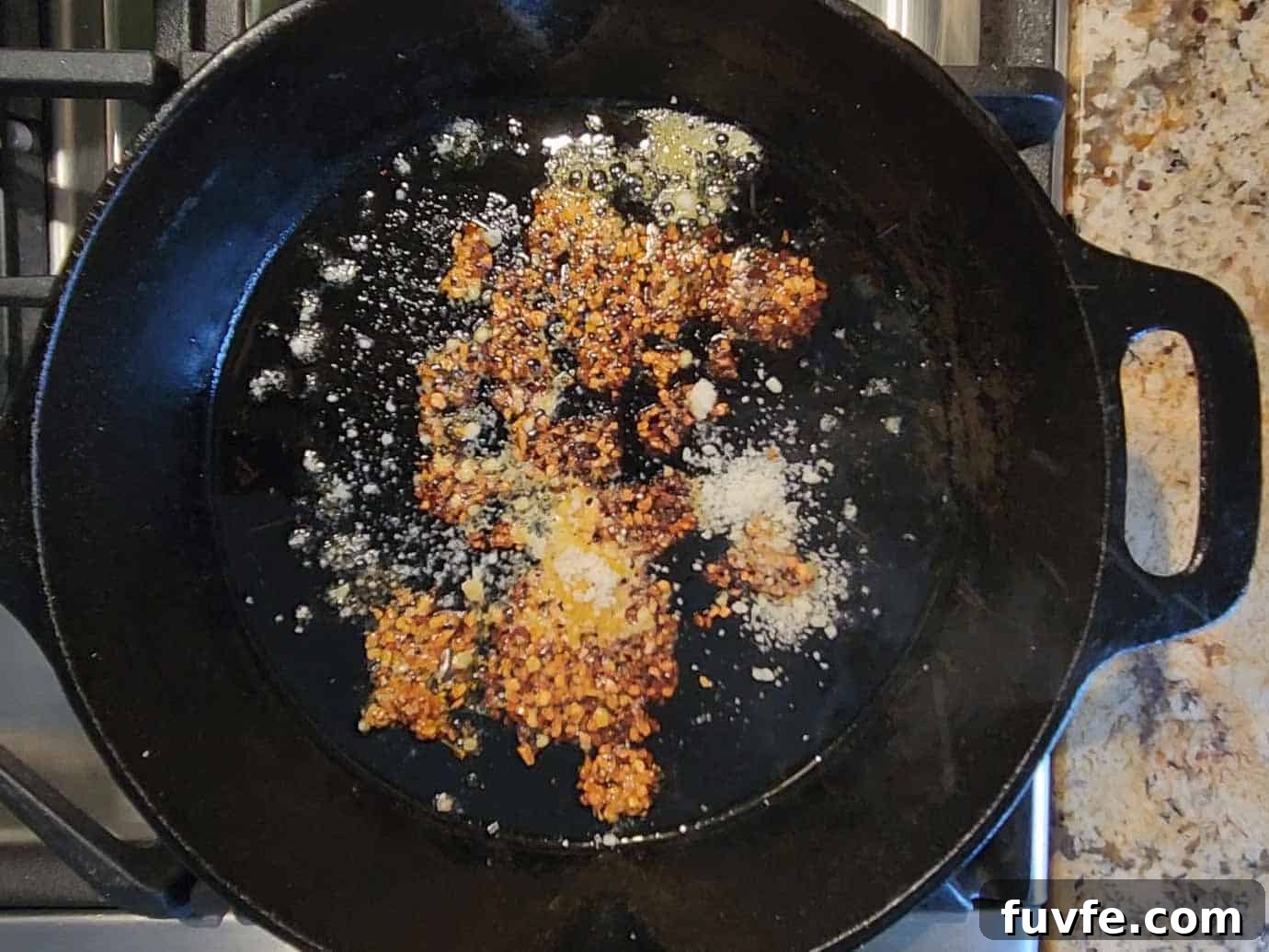 Parmesan Chili Crisp Fried Eggs: Crispy Sunny-Side with Heat 5 Chili crisp and parmesan cheese added to a hot skillet.
