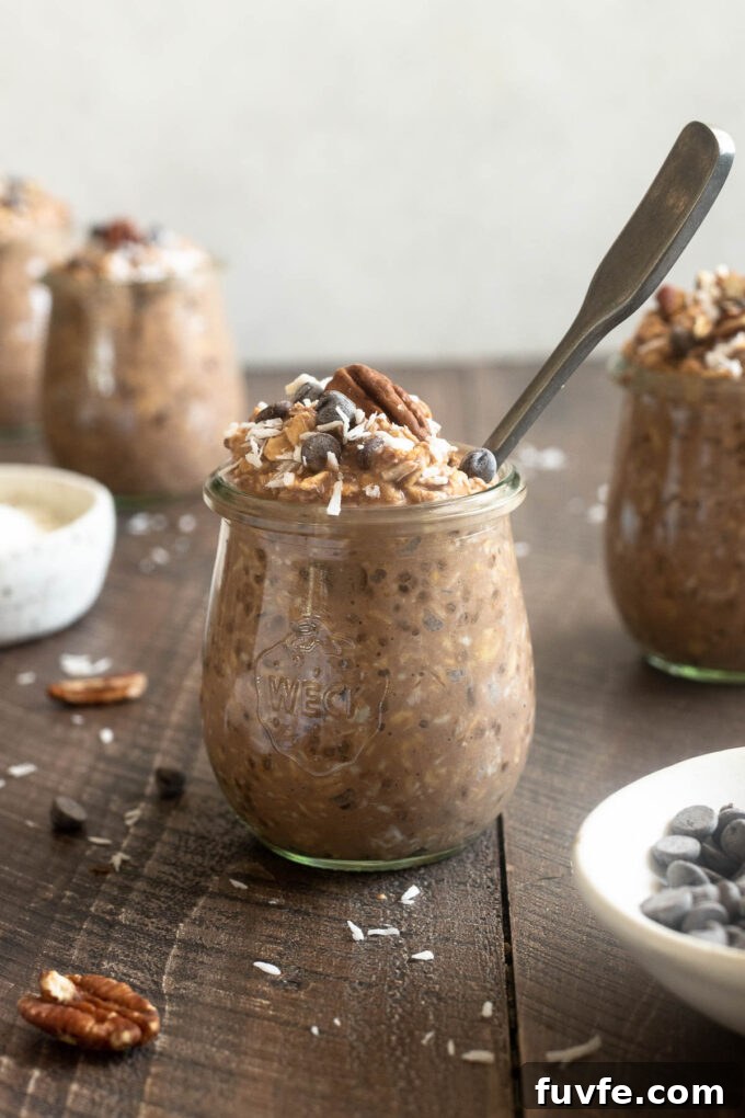 Creamy German Chocolate Overnight Oats Recipe 3 Chocolate overnight oats in a jar with a spoon digging in.