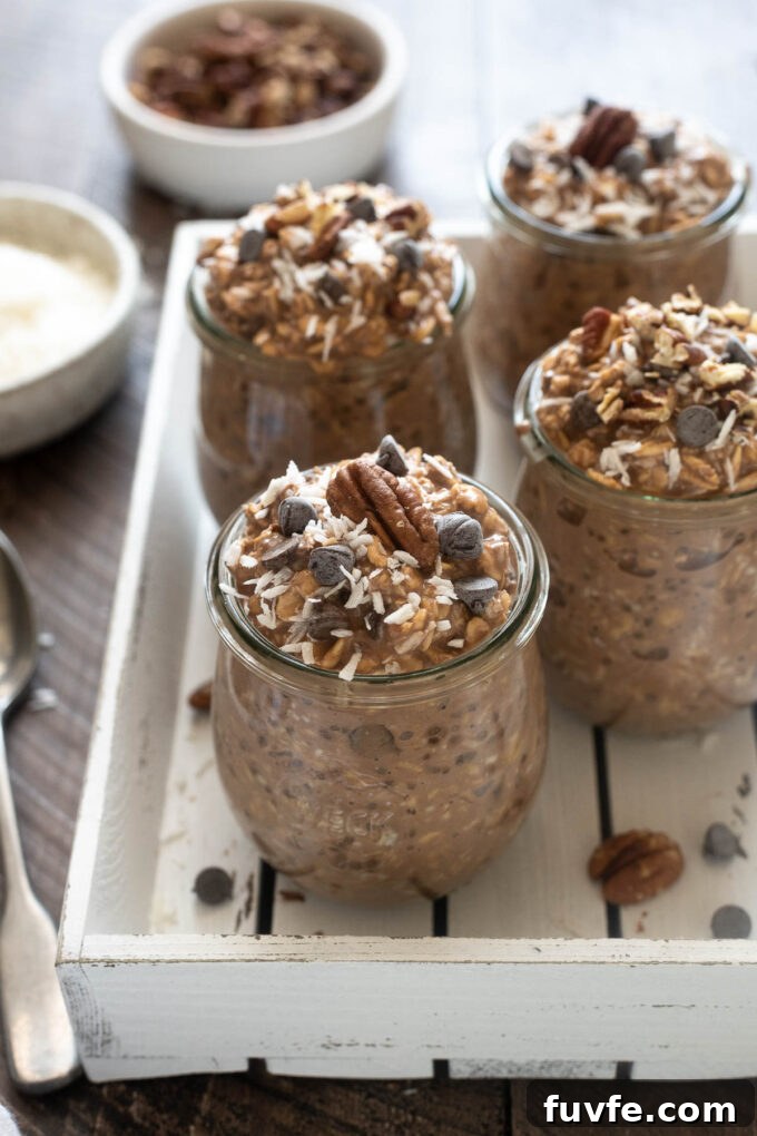 German Chocolate Overnight Oats Recipe 5 Chocolate overnight oats in jars topped with pecans and coconut.
