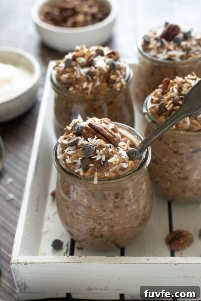 German Chocolate Overnight Oats Recipe 6 German chocolate overnight oats in jars with spoon digging in.