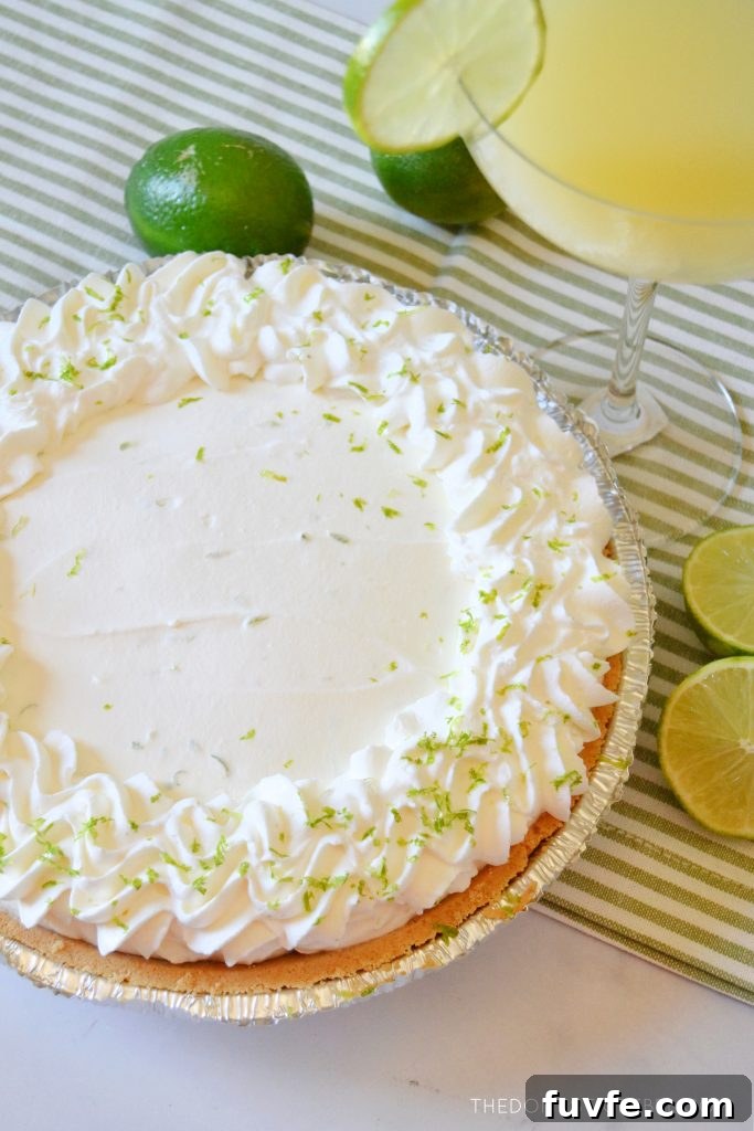 a beautiful margarita pie with limes around it