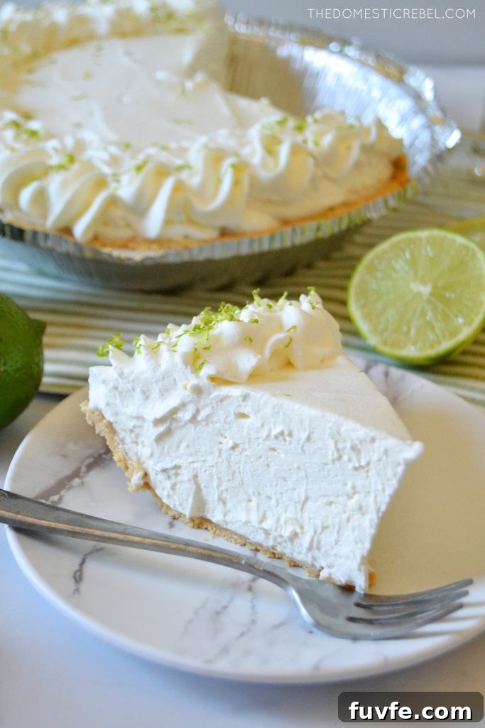 No-Bake Margarita Pie Recipe: Creamy Lime Cocktail Dessert 4 a piece of margarita pie on a white plate with a whole pie in the background