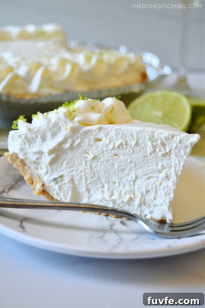 No-Bake Margarita Pie Recipe: Creamy Lime Cocktail Dessert 6 sideways shot of a piece of margarita pie on a marble plate