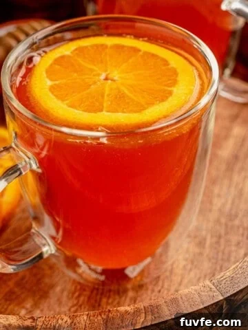 A warm cocktail in a clear mug.