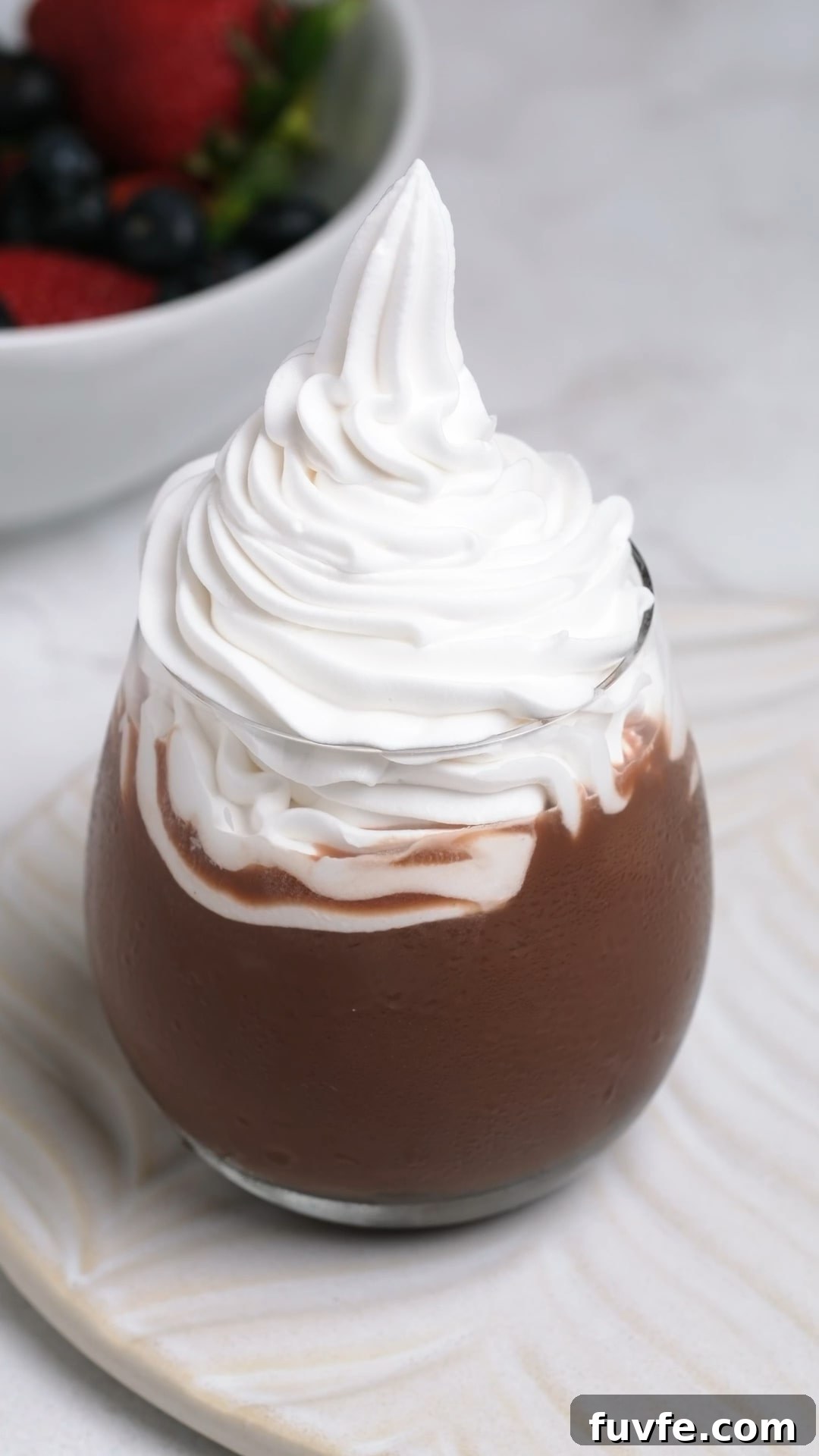 Bakery Tip: How to Make Stable Whipped Cream Frosting That Holds Up 2 Tall thick and fluffy stabilized whipped cream in a cup.