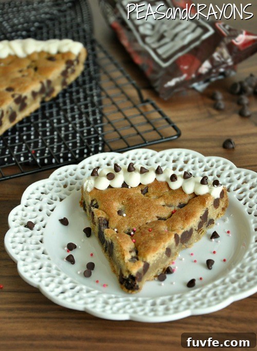 sliced chocolate chip cookie cake with vanilla icing