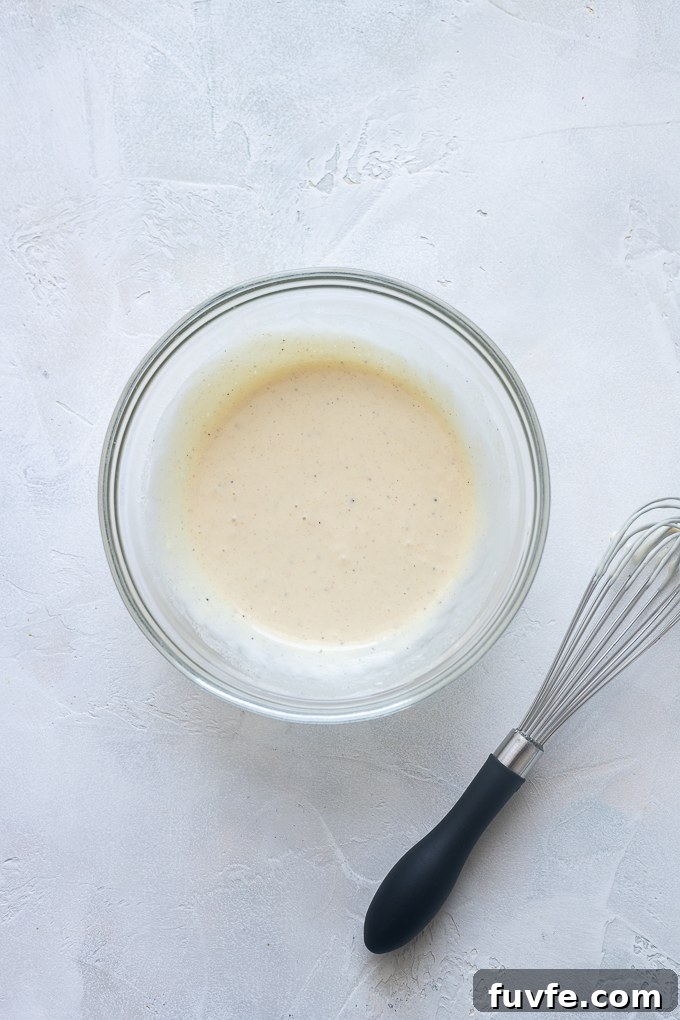 Dressing for tarragon chicken salad in a bowl.