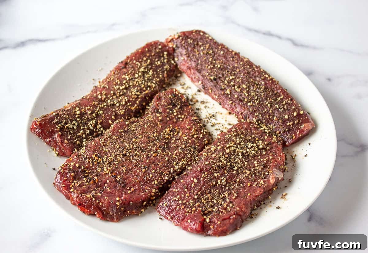 Elk Steak au Poivre Recipe: Peppercorn-Crusted Venison Steak 5 Steaks covered with crushed pepper.