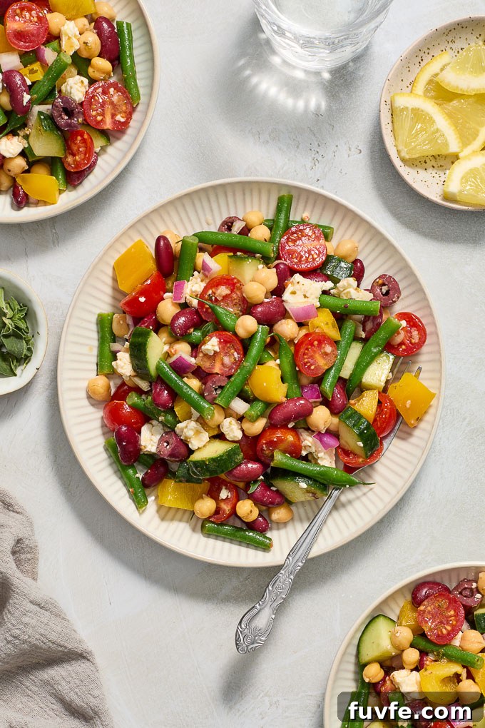 Mediterranean bean salad with feta on plates.