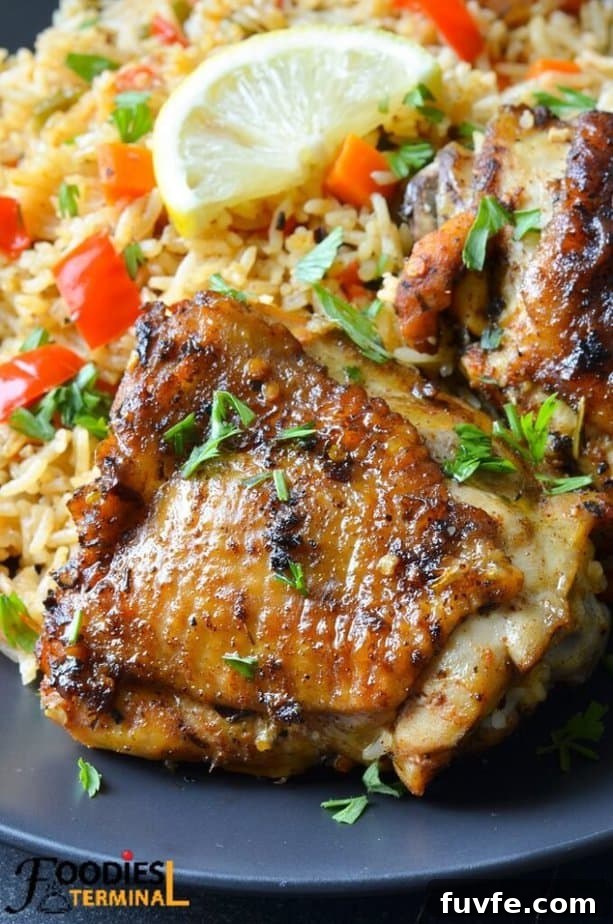 Instant Pot Chicken Thighs with Fluffy White Rice 2 Instant pot chicken thighs and white rice in a black plate