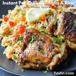 Instant Pot Chicken Thighs with Fluffy White Rice 10 bone in skin on chicken thighs and white rice served on a black plate with lemon wedge
