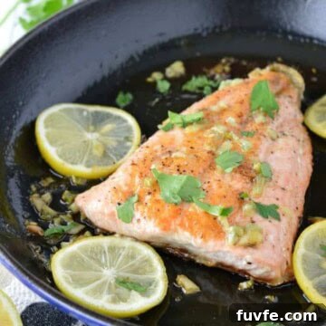 Honey garlic salmon on in skillet on dish towel.