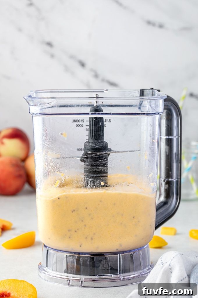 Peach mango smoothie in a blender