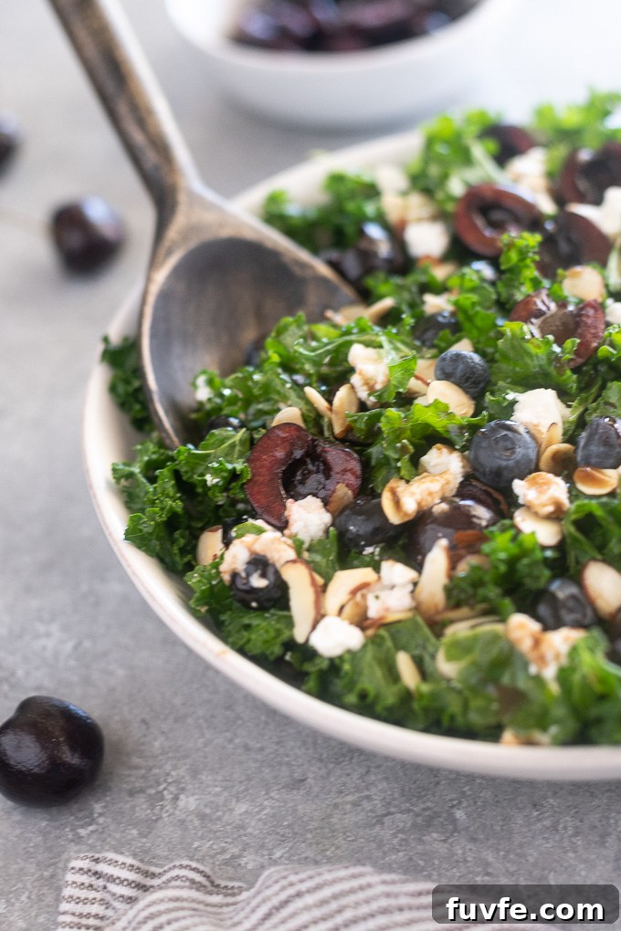 Kale, Cherry and Goat Cheese Salad Recipe 7 Summer kale salad in a bowl with servers