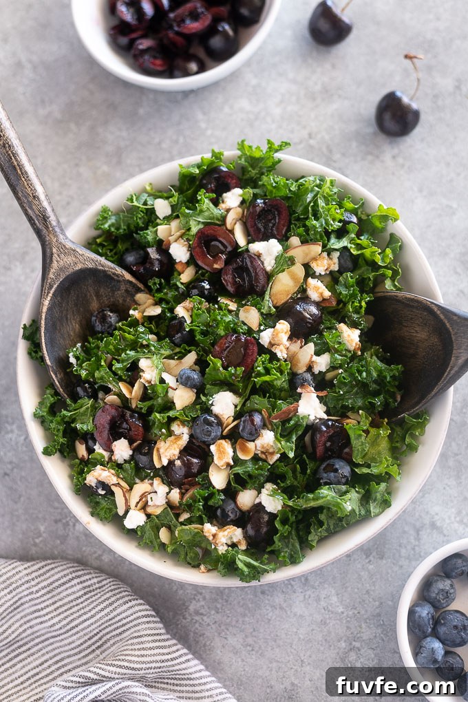 Kale, Cherry and Goat Cheese Salad Recipe 8 Kale cherry salad in serving bowl with salad servers