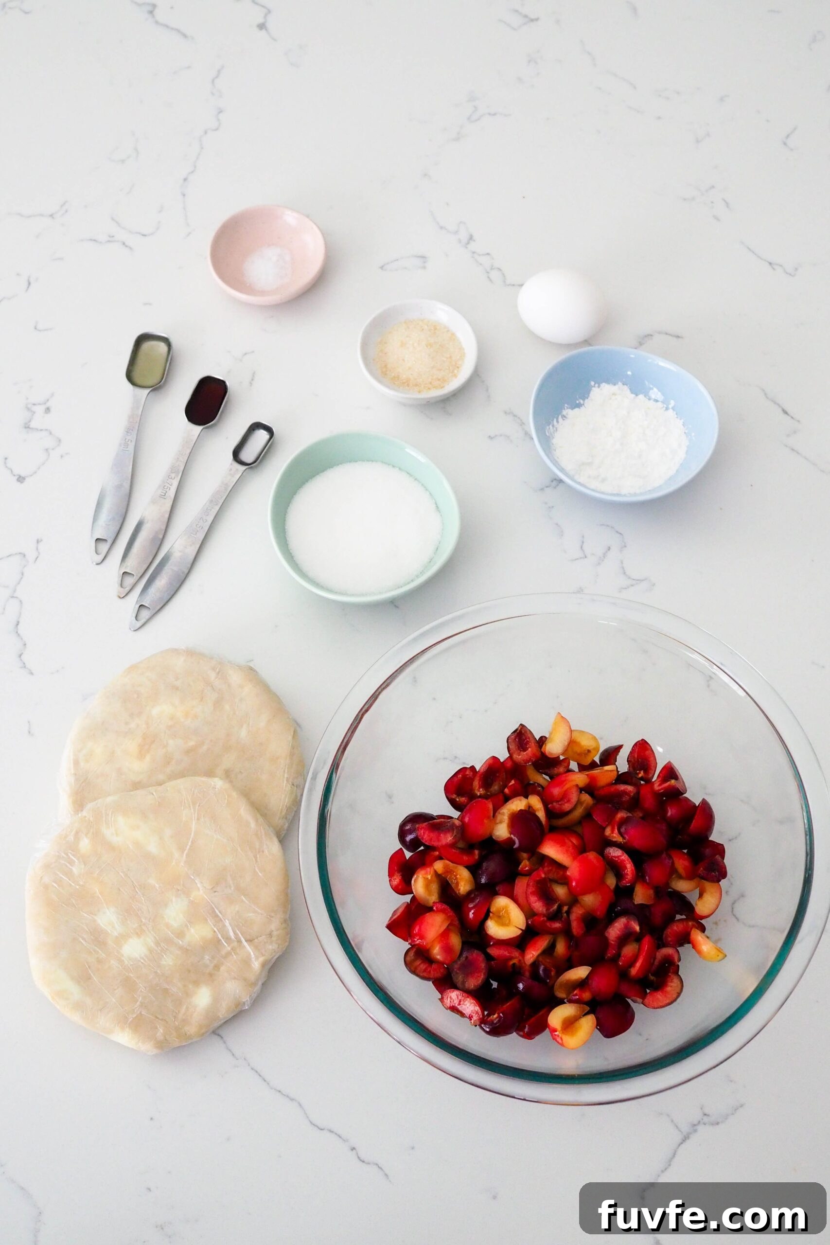 Ingredients for mini cherry pies laid out on a counter.