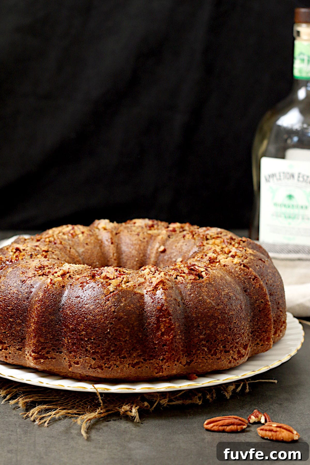 Homemade Caribbean Rum Cake with Toasted Pecans (No Mix) 2 A whole Caribbean Rum Cake on a large white plate.