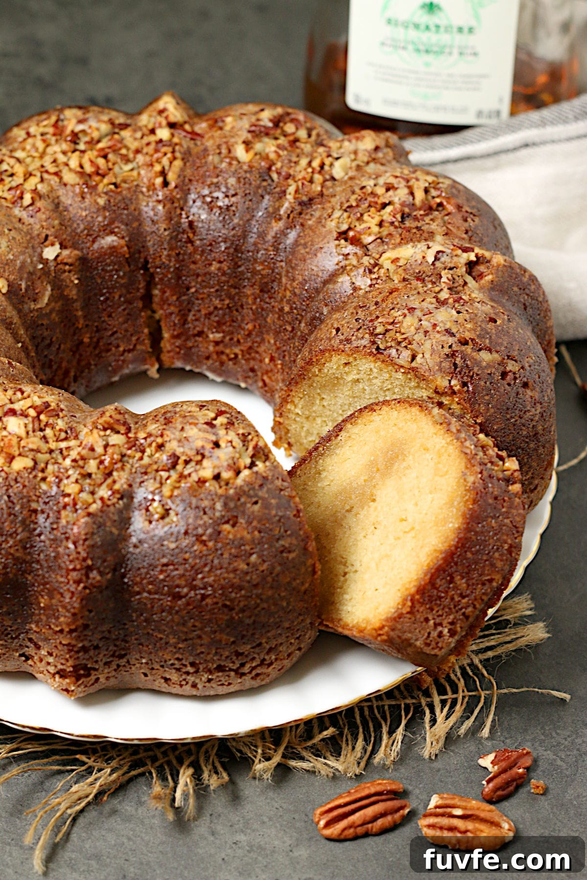 Homemade Caribbean Rum Cake with Toasted Pecans (No Mix) 3 A whole Caribbean Rum Cake with a slice removed.