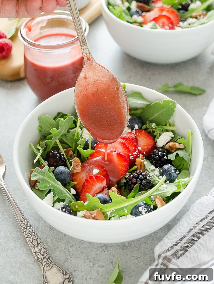 Homemade Raspberry Vinaigrette Recipe for Salads 5 Raspberry balsamic vinaigrette drizzling over a salad.