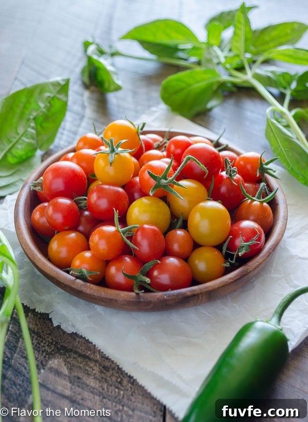 cherry tomatoes on a plate with basil