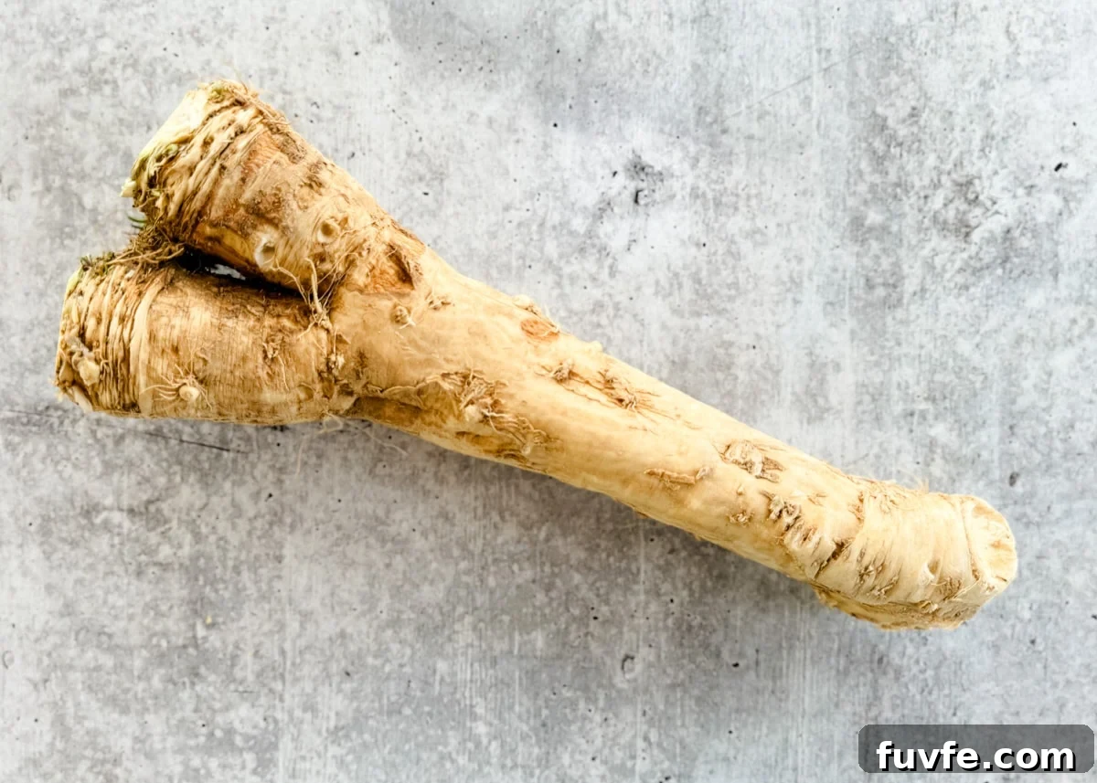 overhead of fresh horseradish root on a gray board