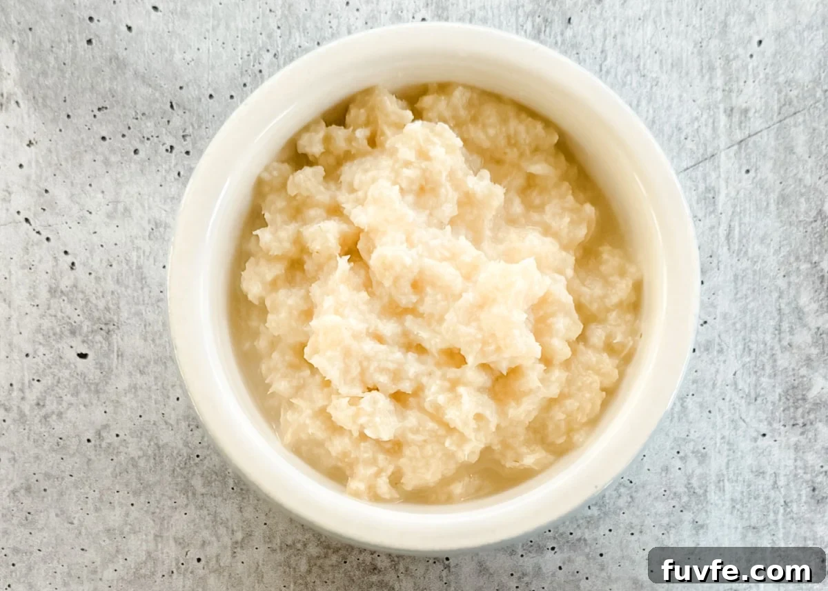 overhead of prepared horseradish in a bowl on a gray board