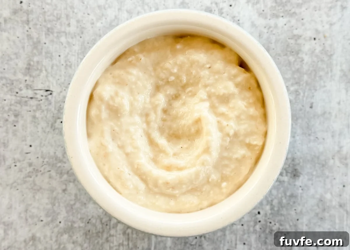 overhead of cream style horseradish in a bowl on a gray board