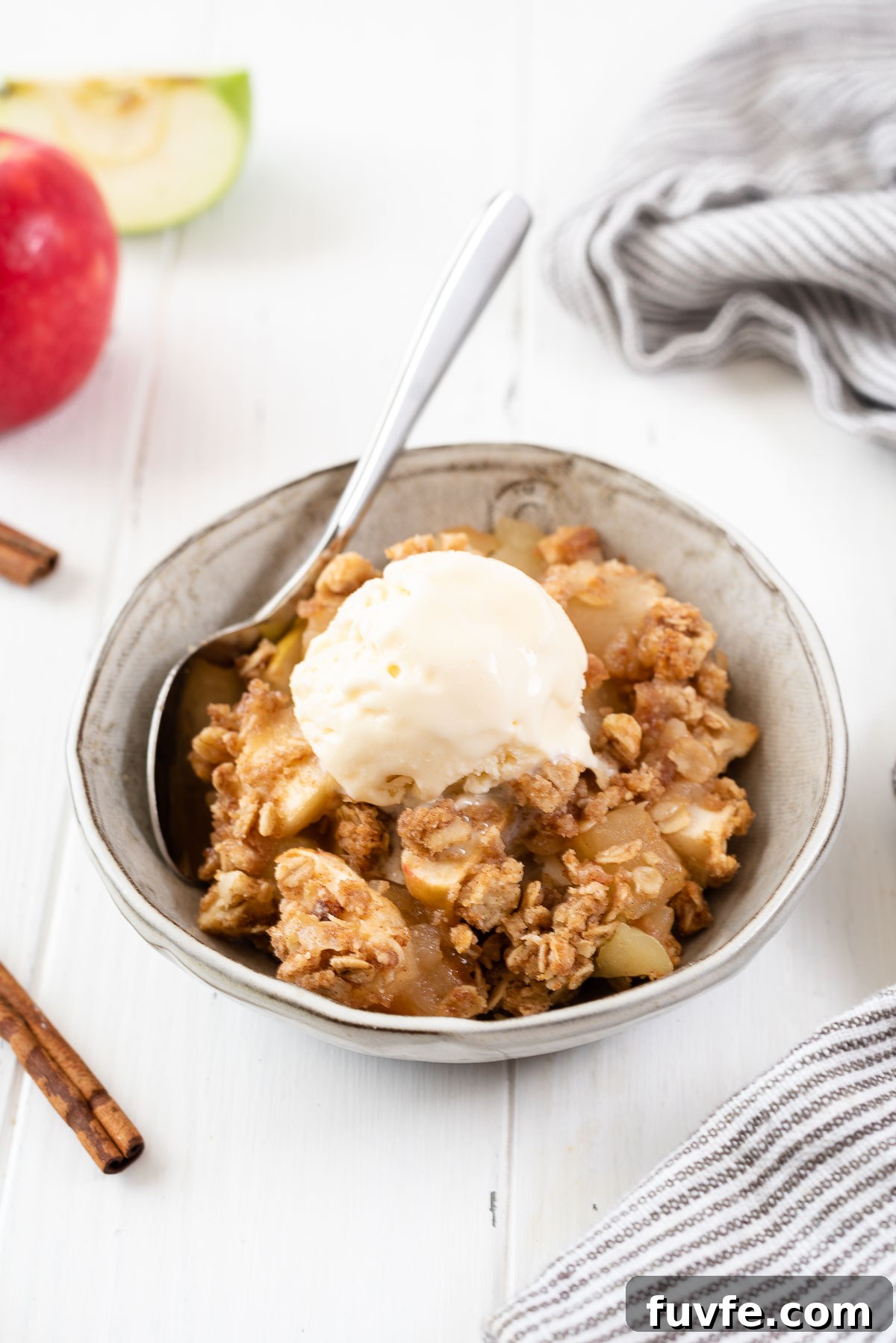 Classic Apple Crisp Recipe with Crunchy Oat Topping 9 Serving of apple crisp in a bowl with ice cream on top
