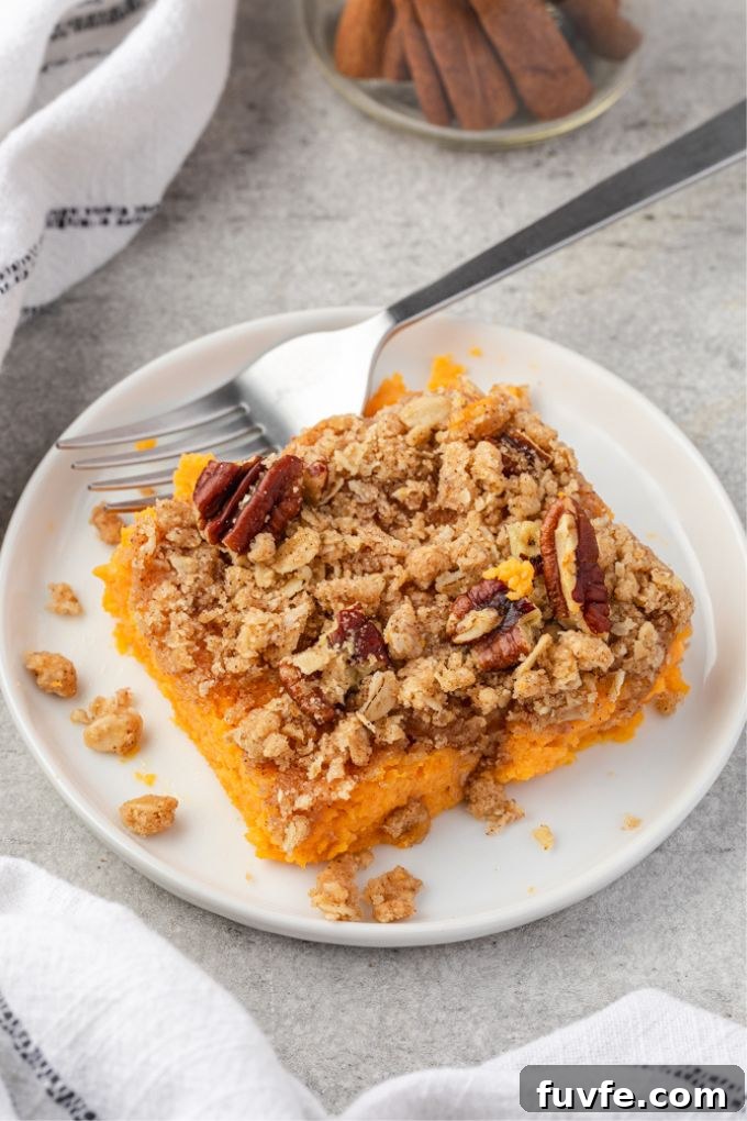 Sweet Potato Casserole with Brown Sugar Streusel 7 Serving of sweet potato casserole with streusel topping on a plate