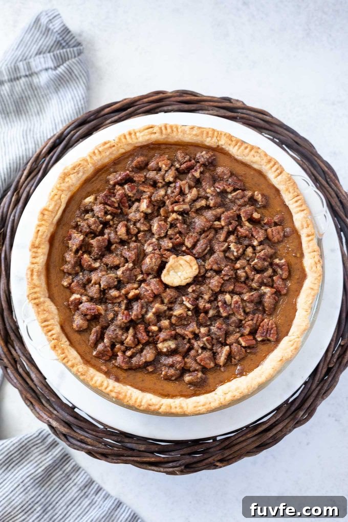 Pumpkin pecan pie on a cake stand
