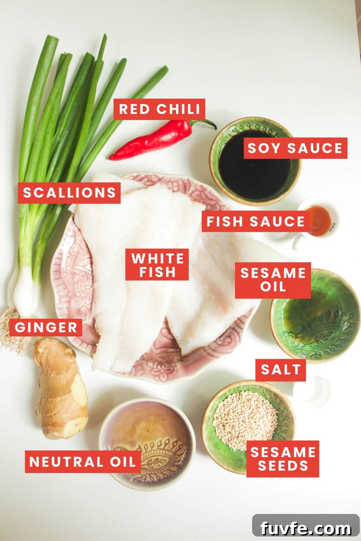 Ingredients for sizzling oil steamed fish laid out and labelled.
