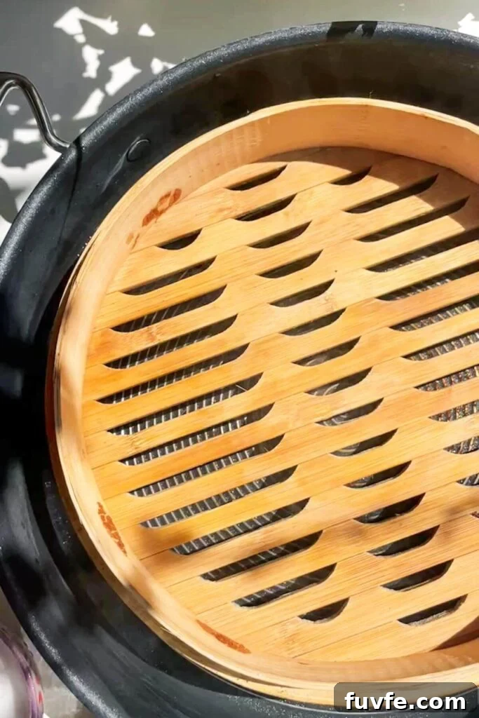 Bamboo steamer basket inside a large pan.