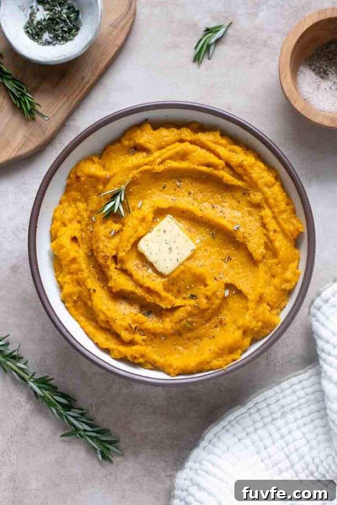 Velvety Kabocha Squash Mash Recipe 3 Kabocha mash in a serving bowl with butter and rosemary garnish.