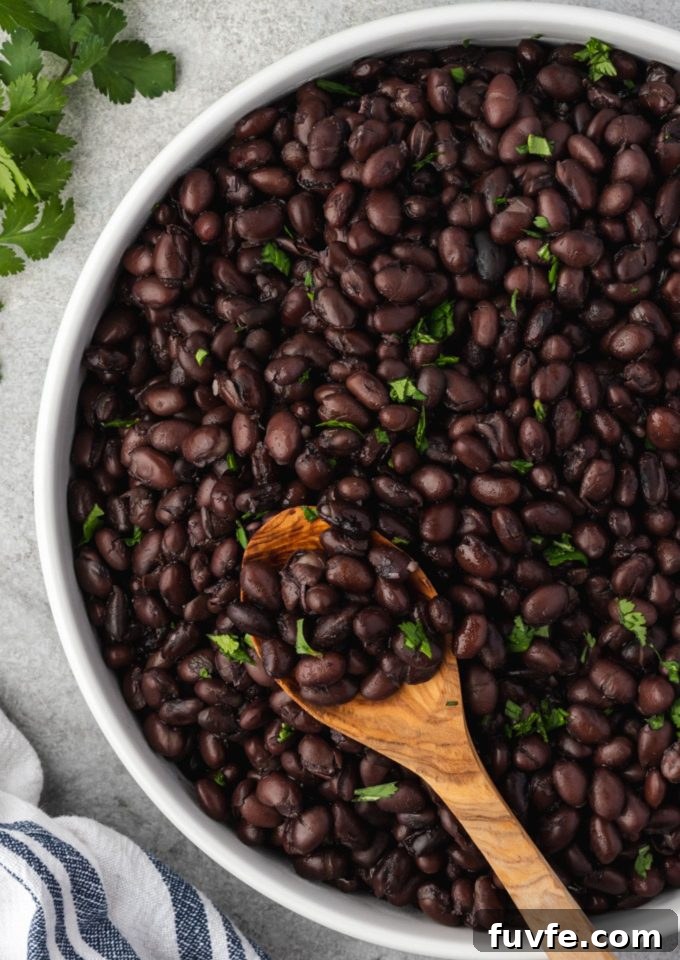 Instant pot black beans in a bowl with a spoon