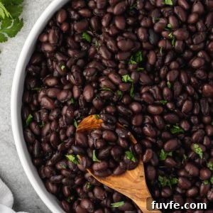 Instant pot black beans in a bowl with a spoon