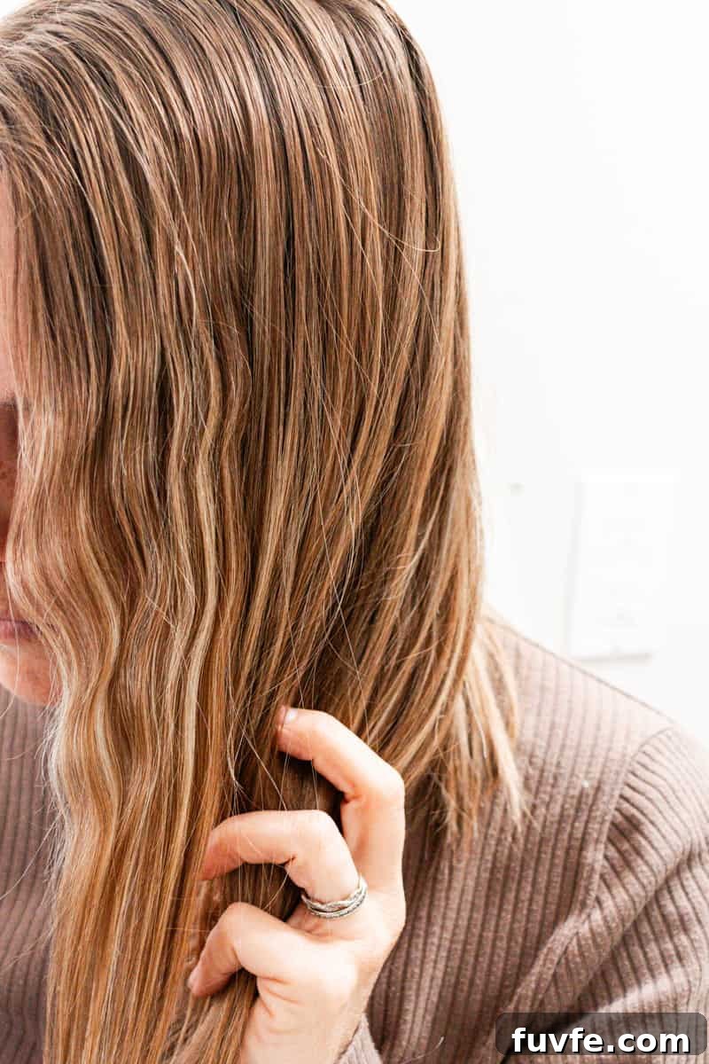 Running fingers through the hair of the curly waves.