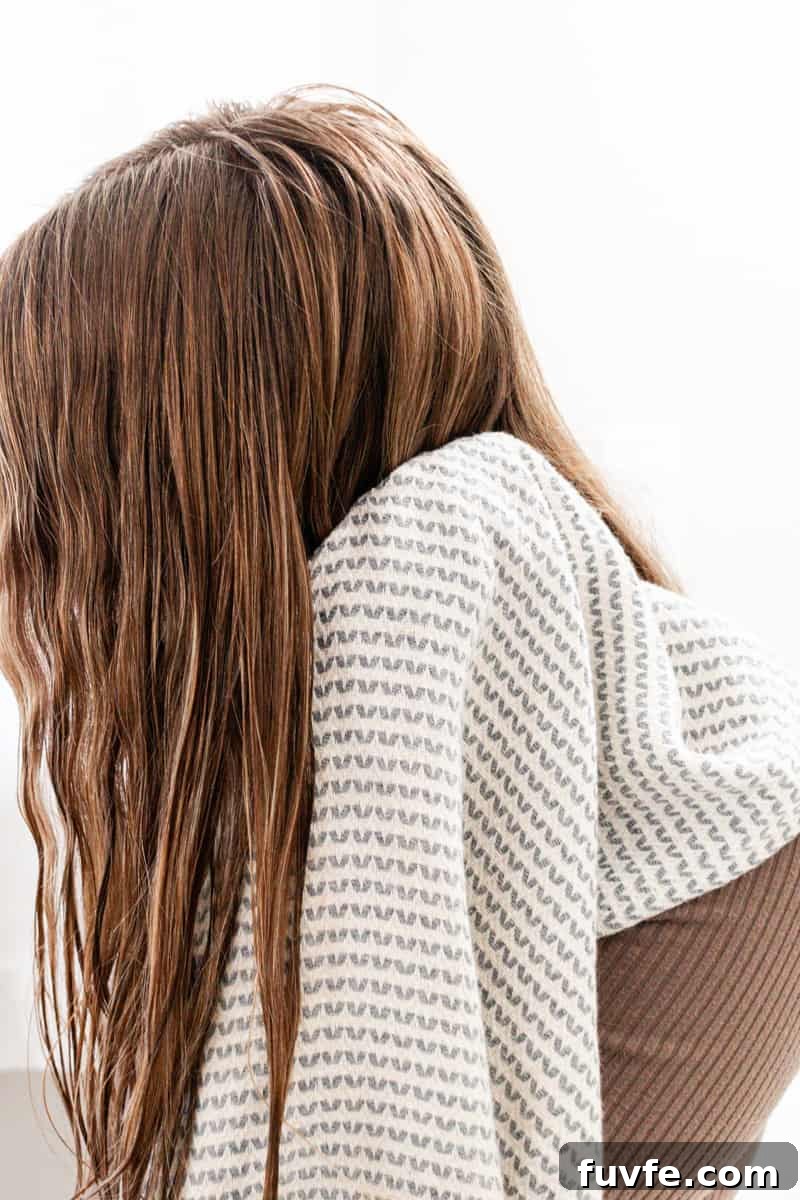 Pat drying hair with a clean towel to prevent hair damage.