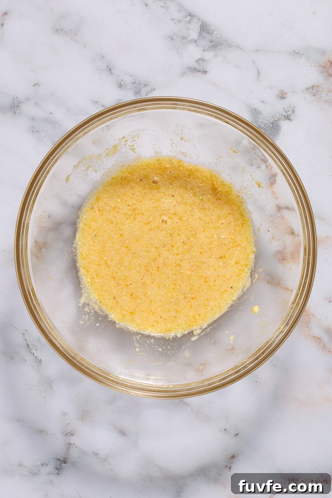 Cornmeal, sugar, baking powder and salt combined in a mixing bowl.