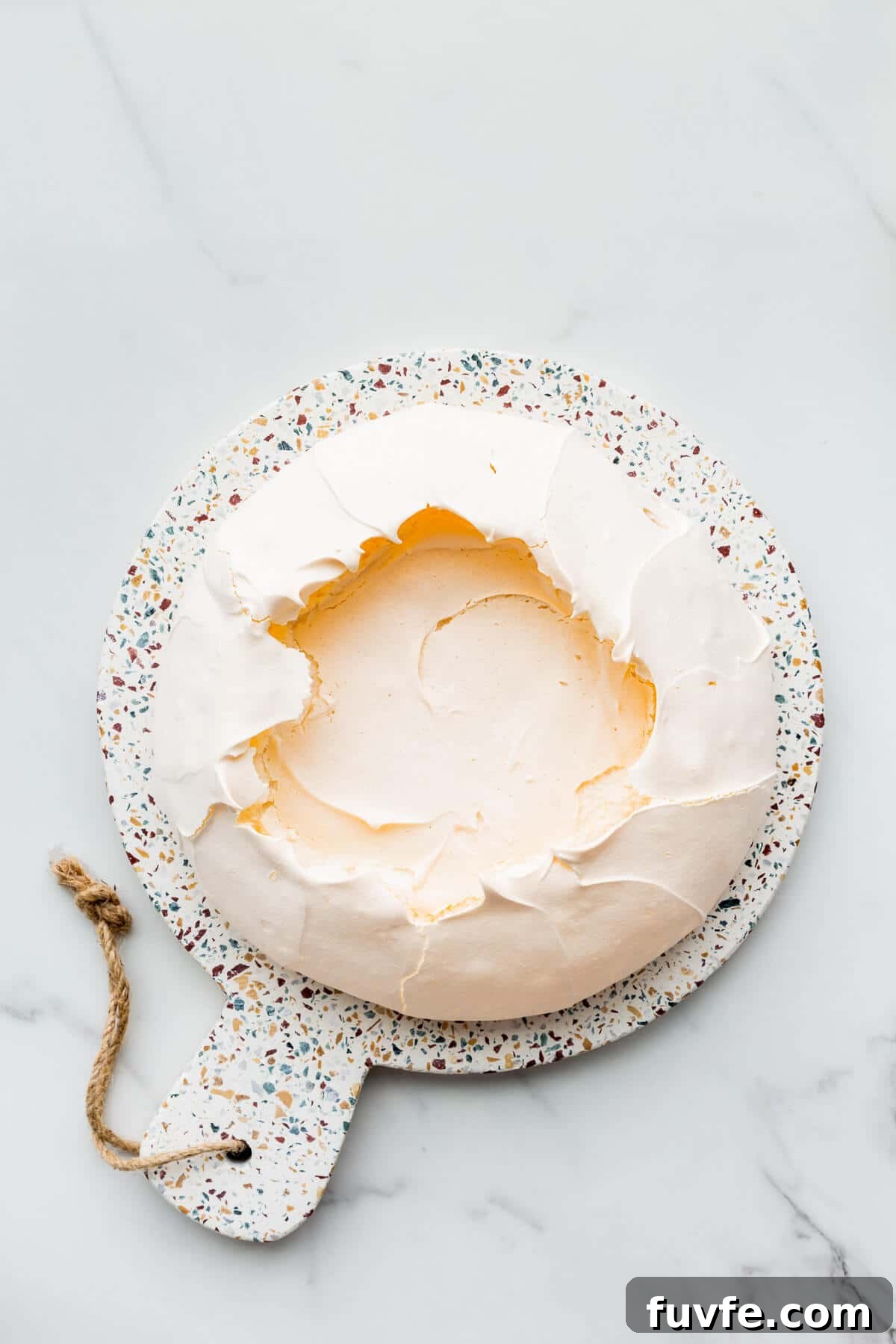 Classic Pavlova Recipe: Crispy Meringue with Fresh Fruit 6 Freshly baked pavlova, ready to be filled with whipped cream and berries.