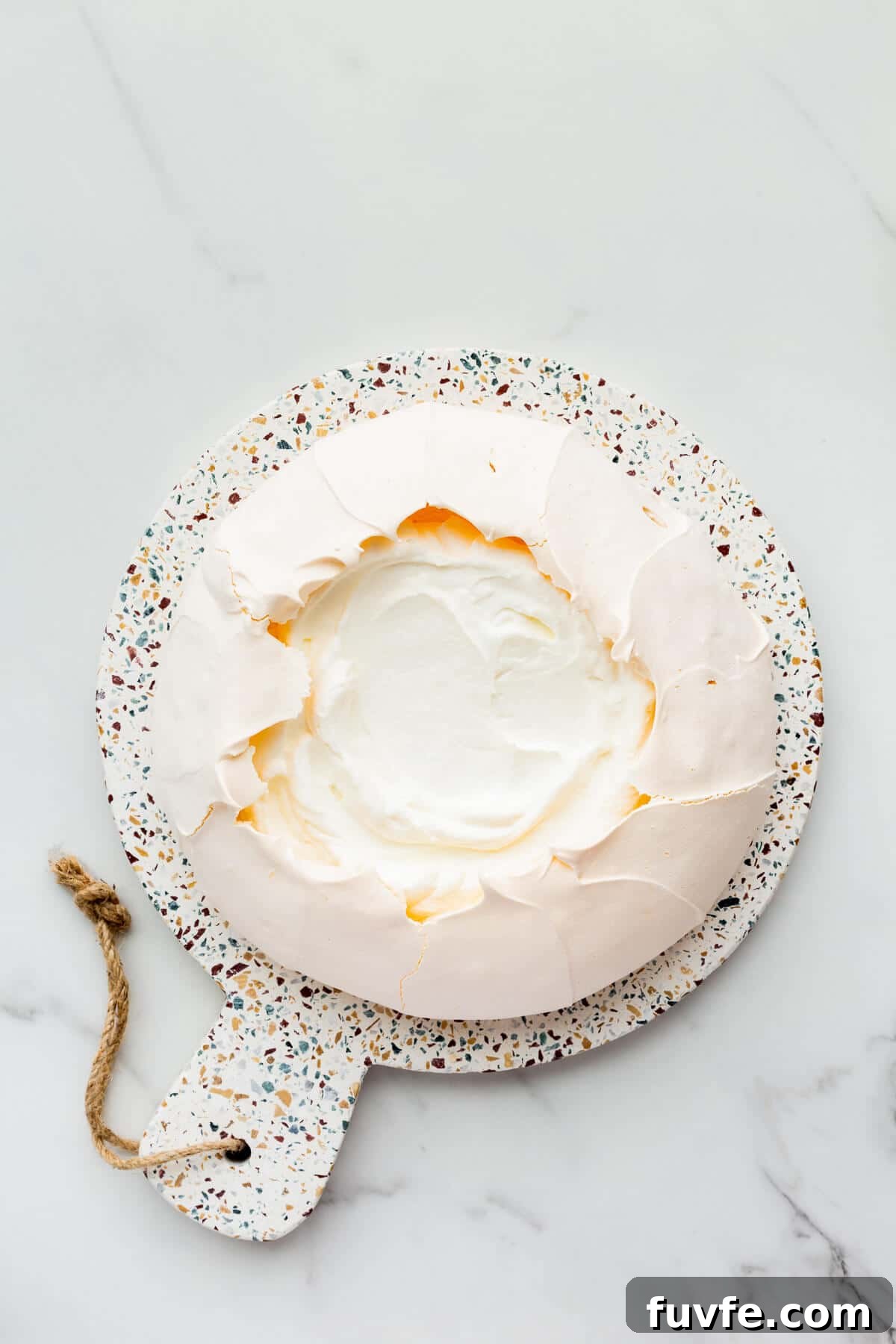 Classic Pavlova Recipe: Crispy Meringue with Fresh Fruit 7 Pavlova cake filled with whipped cream.