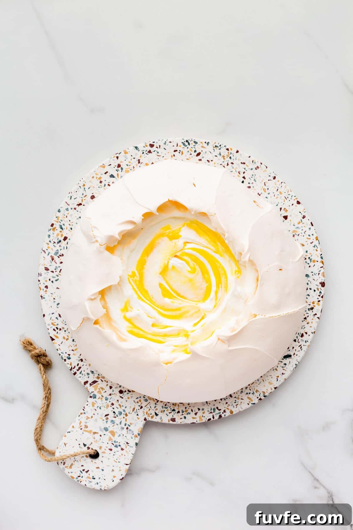 Classic Pavlova Recipe: Crispy Meringue with Fresh Fruit 8 Pavlova cake filled with whipped cream and lemon curd.