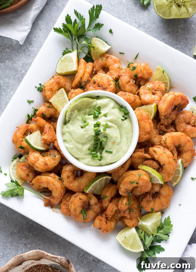Blackened shrimp on a platter with avocado ranch dressing